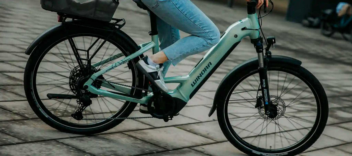 en blå el-hybridcykel i stad